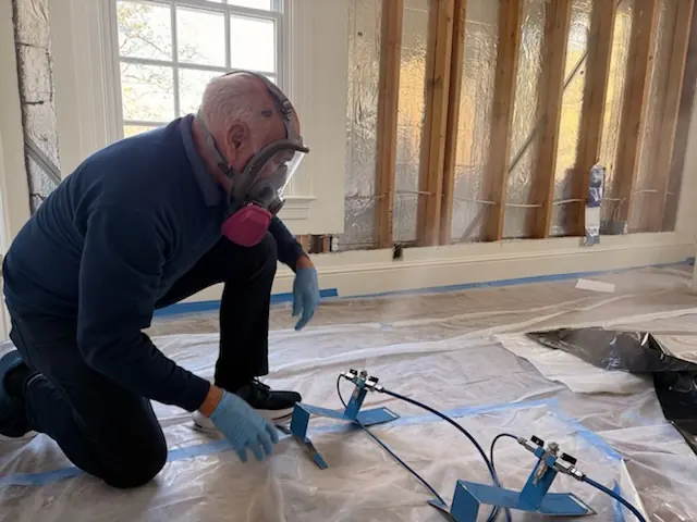 A restoration technician setting drying equipment in an Burbank home stripped to the studs